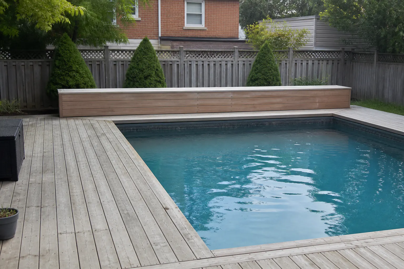Existing pool with an above-deck bench housing for a retrofit cover