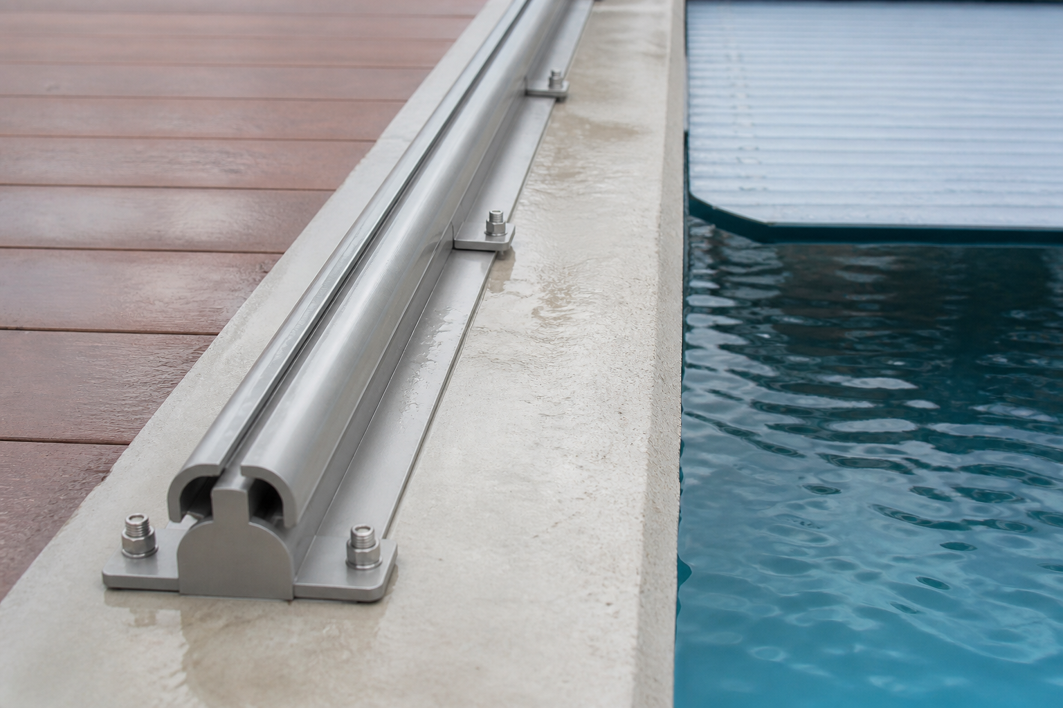 Close view of a deck-mounted automatic pool cover track